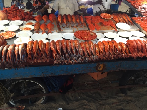 Sea fish marinated with spicy masala, notice the fiery red color. Fish fry stall at Marina Beach, Chennai.