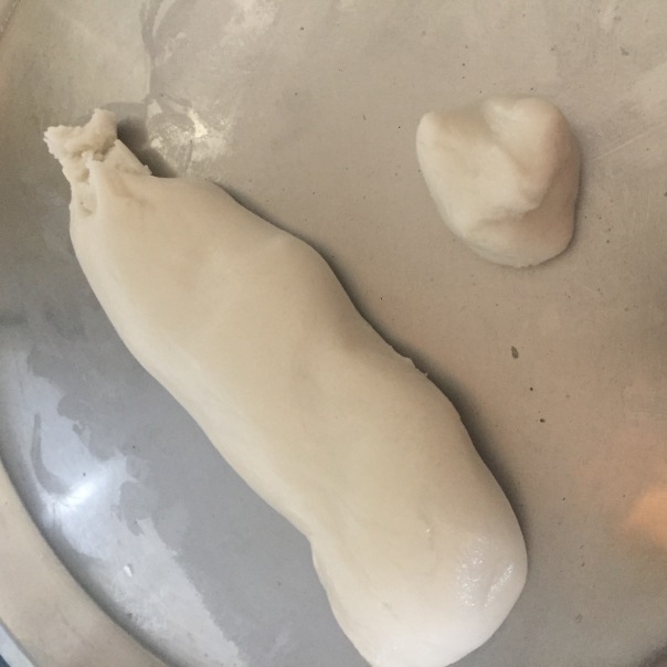 Cut equal-sized small dough portions from the Anarsa dough roll.